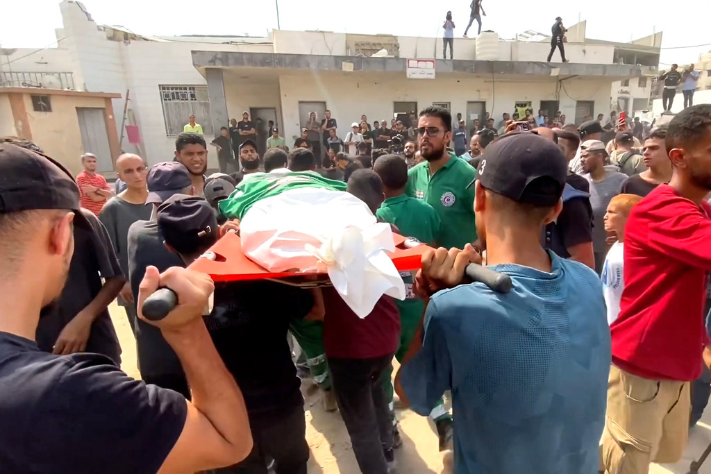 Mourners carry the body of a journalist killed in an Israeli airstrike on Gaza on August 10, 2025.